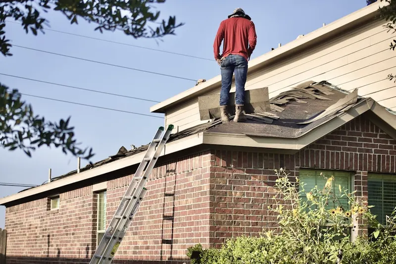Professional roofer working on a residential roof in East Lake Park